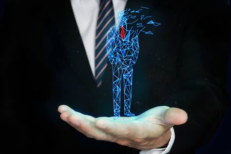 businessman showing glowing digital man on handの写真素材