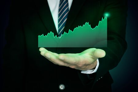 glowing transparent price chart on hand's business man, glowing investment chart, successful conceptの写真素材