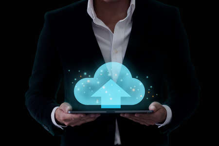 clouds polygonal and business concept, businessman holding cloud hologramの写真素材