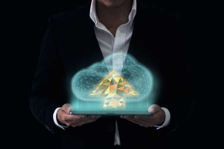 clouds polygonal and business concept, businessman holding cloud hologramの写真素材