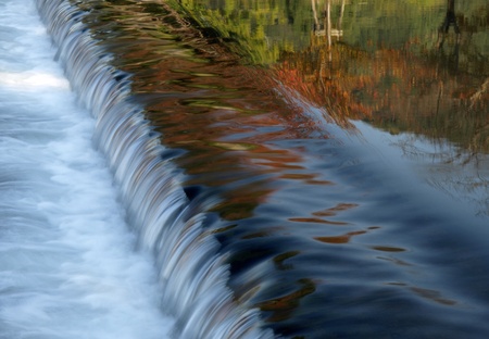 Little weir make a little waterfall in the riverの写真素材