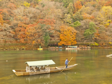 ARASHIYAMA, KYOTO, JAPAN - CIRCA DECEMBER 4, 2009  Boat with tourists on Katsura river in Arashiyama area, Kyoto, Japan on December 4, 2009 のeditorial素材