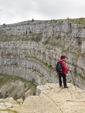 CREUX DU VAN, NEUCHATEL, SWITZERLAND - SEP 9: An unidentified hiker look at the natural rocky cirque of Creux du Van on September 9, 2010 in Neuchatel, Switzerland.のeditorial素材