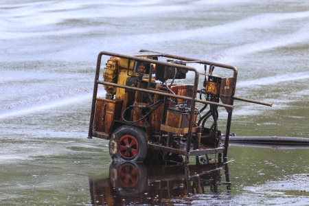 Oil pump evacuate crude oil spilled on the beach in Thailand 