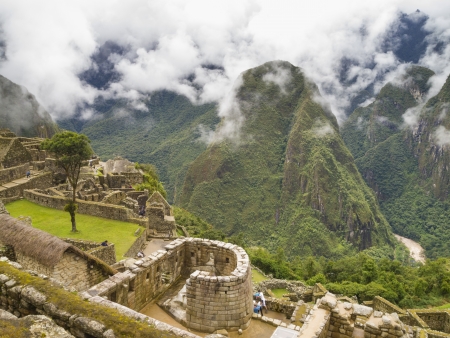 MACHU PICCHU, CUSCO, PERU - MAR 15  Tourists visit in the Temple of The Sun in a pre-Columbian 15th-century Inca site of Machu Picchu after rain on Mar 15, 2011 in Cusco region, Peru のeditorial素材