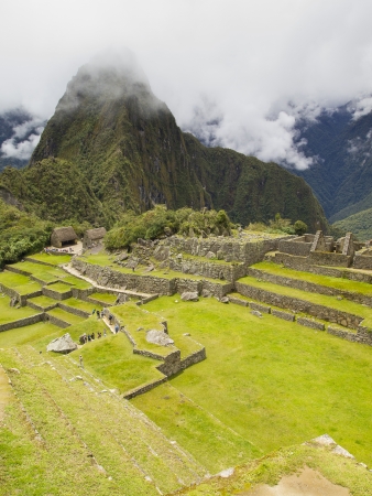 MACHU PICCHU, CUSCO, PERU - MAR 15  Tourists visit the Main Square in a pre-Columbian 15th-century Inca site of Machu Picchu after rain on Mar 15, 2011 in Cusco region, Peru のeditorial素材