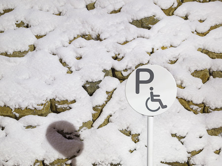 Reserved parking sign for handicapped in night of winter.の写真素材