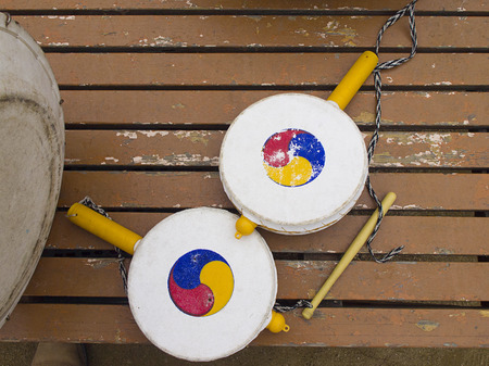 Old Traditional Korean handy drums on old painted wooden floor.の写真素材
