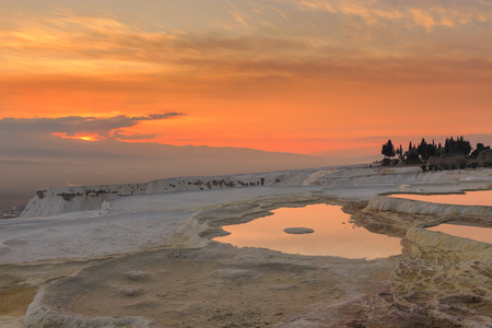 Sunset at Pamukkale with its travertine pools and terraces as foreground, Denizli, Turkey.の写真素材