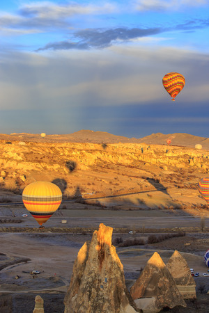 GOREME, TURKEY -JAN 30, 2013: Colorful Hot air balloon fly over Cappadocia, Goreme, Central Anatolia, Turkey. Hot-air ballooning is very popular tourist activity in Cappadocia.のeditorial素材