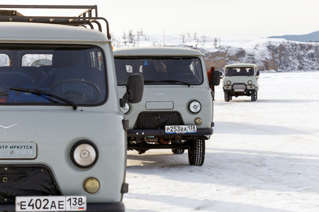 IRKUTSK, SIBERIA, RUSSIA - FEB 22, 2017 : Group of Wazik UAZ-452, the 4WD Russian Minibus waiting for passengers on the ice road of the frozen Lake Baikal in winter. (Selective Focus)のeditorial素材