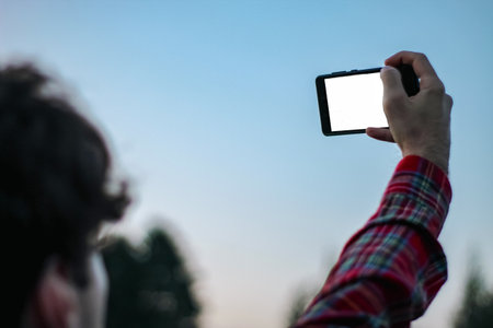 person taking picture of themselves with phone