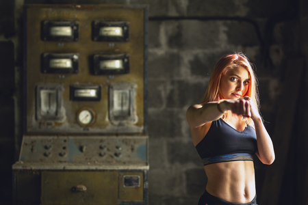 A studio shot of beautiful fitness woman training boxing or functional exerciseの写真素材