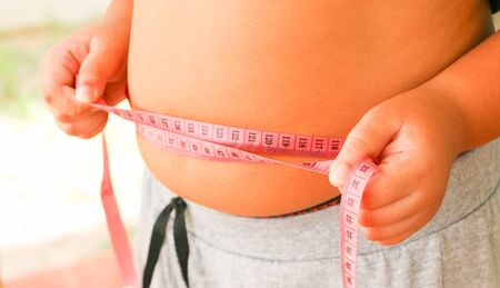 Using a tummy tape measure for an obese boy.
