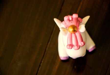 Unicorn on a wooden floor, corner on a hornの写真素材