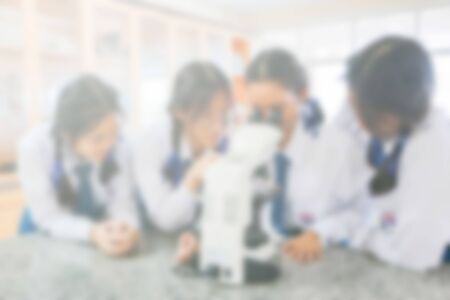 Blurred images, students look at the microscope in the science laboratoryの写真素材