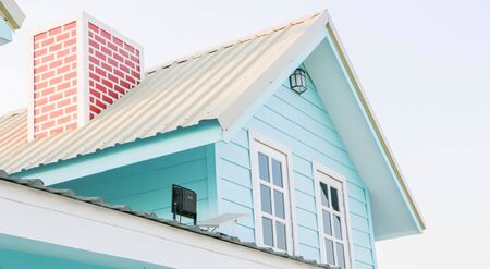The roof of the blue house and red chimneyの写真素材