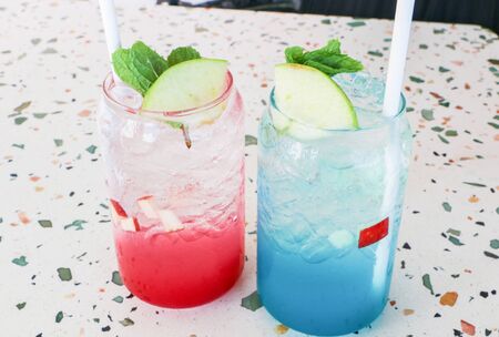 Blue and pink apple soda on a beautiful sea viewの写真素材