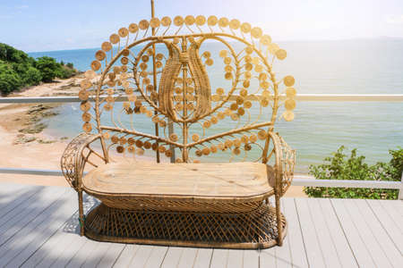 Large wicker chair and sea view