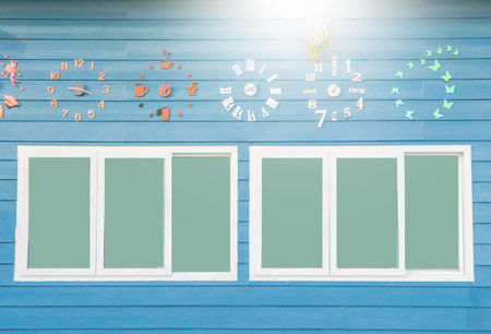 Blue wooden background wall clock and windowsの写真素材