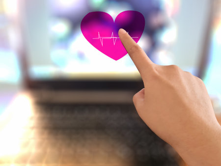 Finger pointing to a heart shape on a blurred backgroundの写真素材