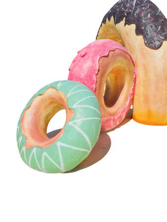 Three large donut statues on isolated white background.の写真素材