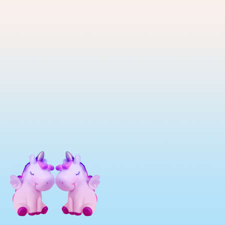 Two unicorn horses face to face on isolated blue white background.の写真素材