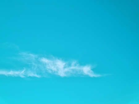 Bright pastel blue sky and few cloudsの写真素材