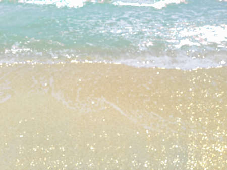 Blur the beach and sand background with bokeh light for summer.