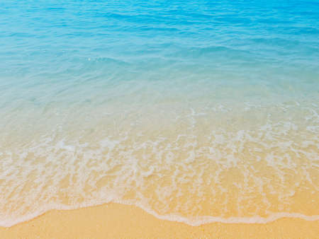 Waves of the sea on the sandy beach. summer vacation beach backgroundの写真素材