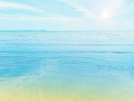 Views of beautiful white sand beaches and turquoise waters. Summer vacation beach background. Waves of the sea on the sandy beach.の写真素材