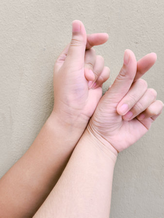 Asian women make small heart-shaped hands. (Korean style) Symbol of loveの写真素材