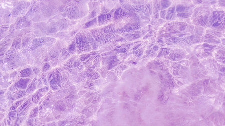 Rippled pattern of clean water in a purple for background