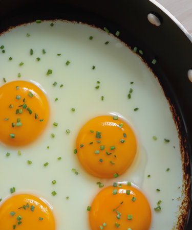 Fried eggs in a frying pan for breakfastの素材