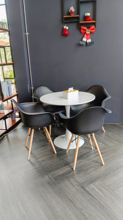 chairs black colors and empty wooden table on wood floor in cafeの写真素材