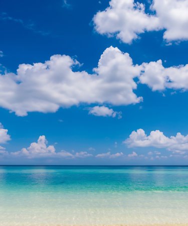 White clouds with blue sky over calm sea beach in tropical slandの素材