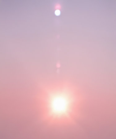 Sunbeam through the haze on pink sky, verticalの素材