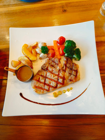 Grilled pork steak with spices and tomato sauce.の写真素材
