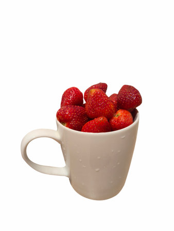 Strawberries in white ceramic cup on isolated white backgroundの写真素材