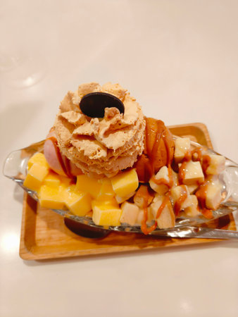Thai tea ice cream topped with whipped cream and delicious pudding.の写真素材