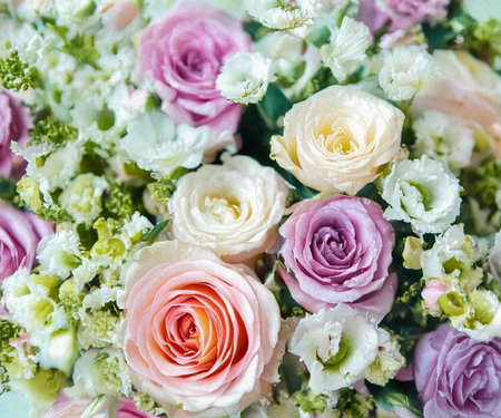Beautiful summer flowers as background. Blossoming delicate roses on blooming flowers festive background, pastel and soft bouquet floral card.の素材