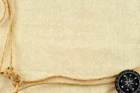 compass and rope on with a canvas of burlapの写真素材