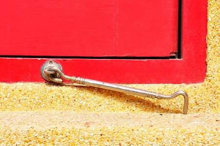 Pair of window hook on red wood windowの写真素材