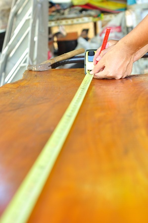 man working and measuring  woodの写真素材