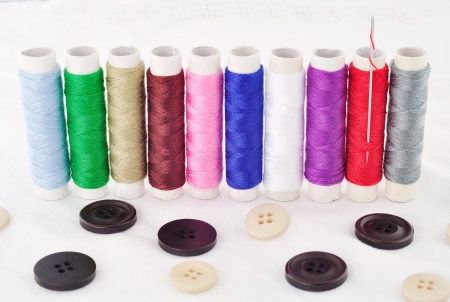 bobbins of thread And Clasper isolated on Fabricの写真素材