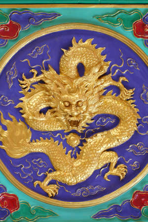 A golden dragon in chinese style. On ceiling.の写真素材