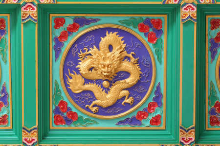 A golden dragon in chinese style. On ceiling.の写真素材