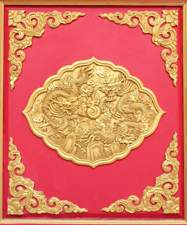 Double golden dragon in chinese style. On red wood.の写真素材