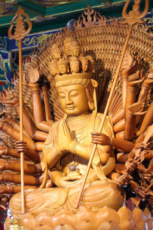 The big kuan has thousand hands. Statue from woods.の写真素材