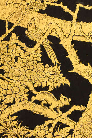 Golden bird and squirrel in Thai style painting.の写真素材